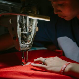 A dedicated seamstress skillfully operates a sewing machine, creating garments with precision and care.